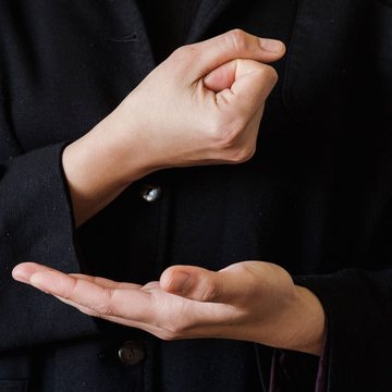 A hand gesturing while explaining, above an open listening palm